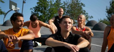 Sportler sitzen nach dem Training auf einem Basketballfeld
